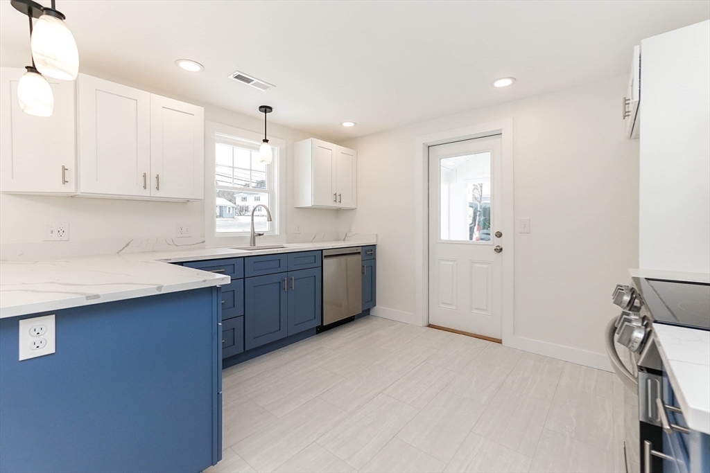 40 Great Road Maynard, MA 01754 - Photo 10 of 30 a kitchen with stainless steel appliances a sink stove and cabinets