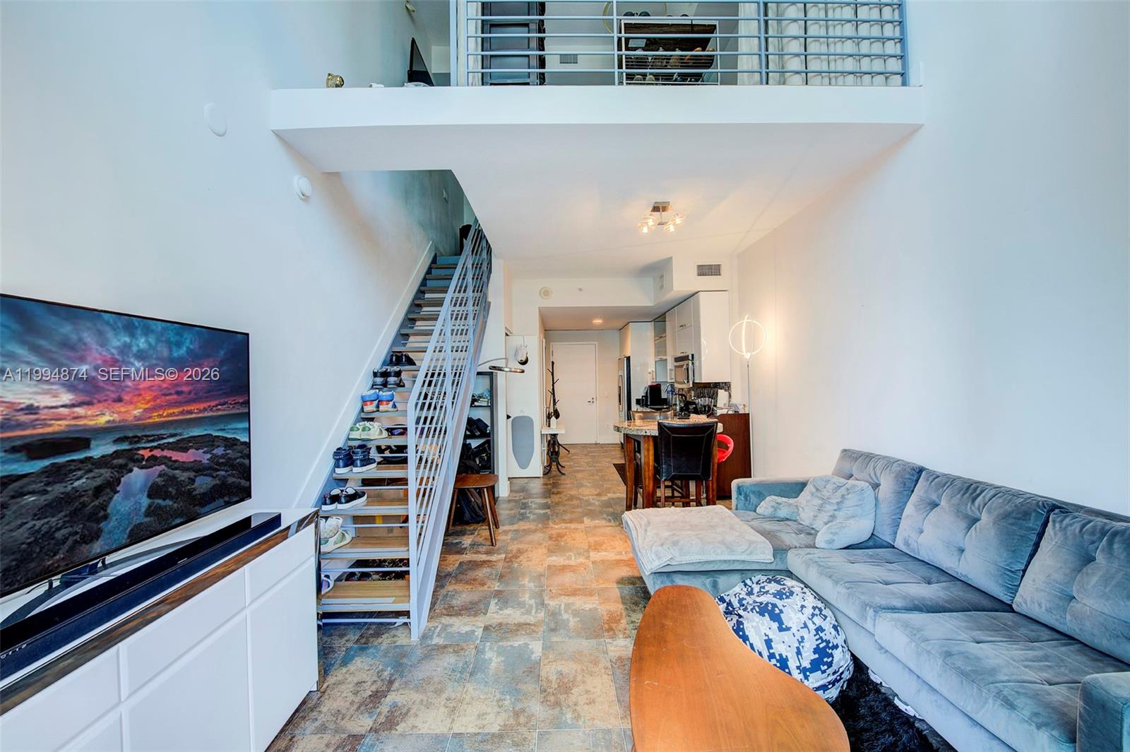 a living room with furniture and wooden floor