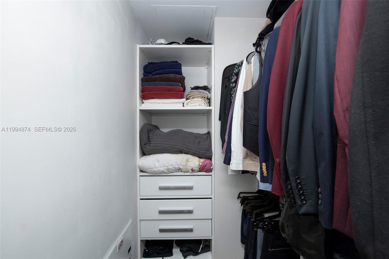 60 Southwest 13th Street, Unit 2820 Miami, FL 33130 - Photo 11 of 25 a view of walk in closet with clothes and shoes