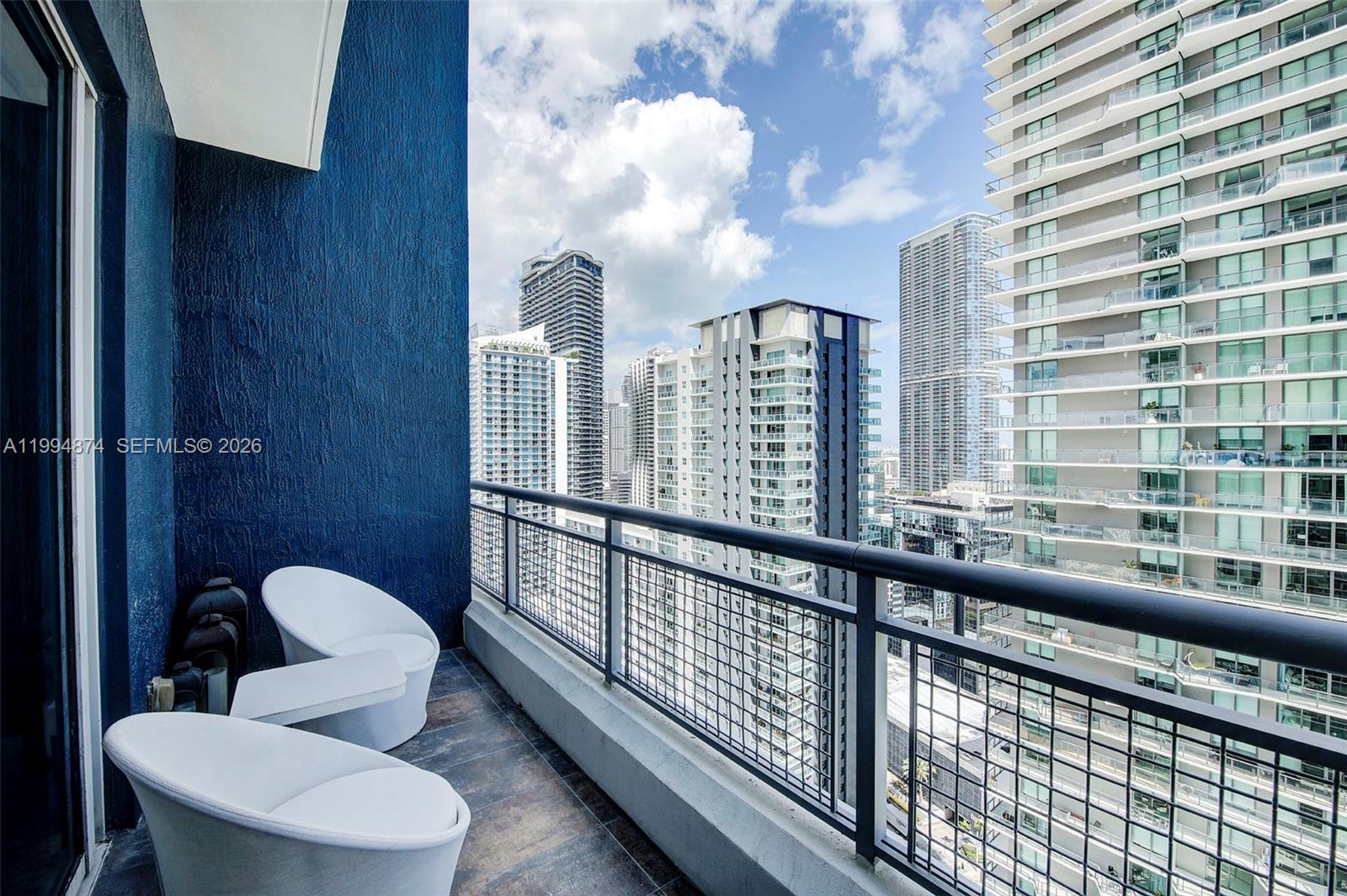 60 Southwest 13th Street, Unit 2820 Miami, FL 33130 - Photo 12 of 25 a view of a balcony with chairs