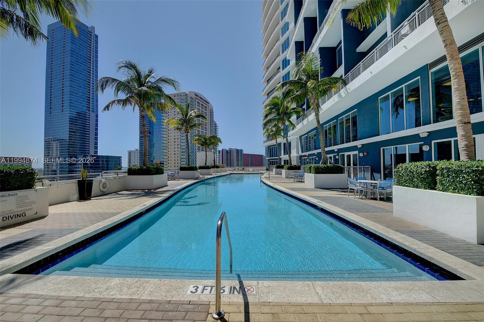 60 Southwest 13th Street, Unit 2820 Miami, FL 33130 - Photo 17 of 25 a swimming pool with outdoor seating and yard