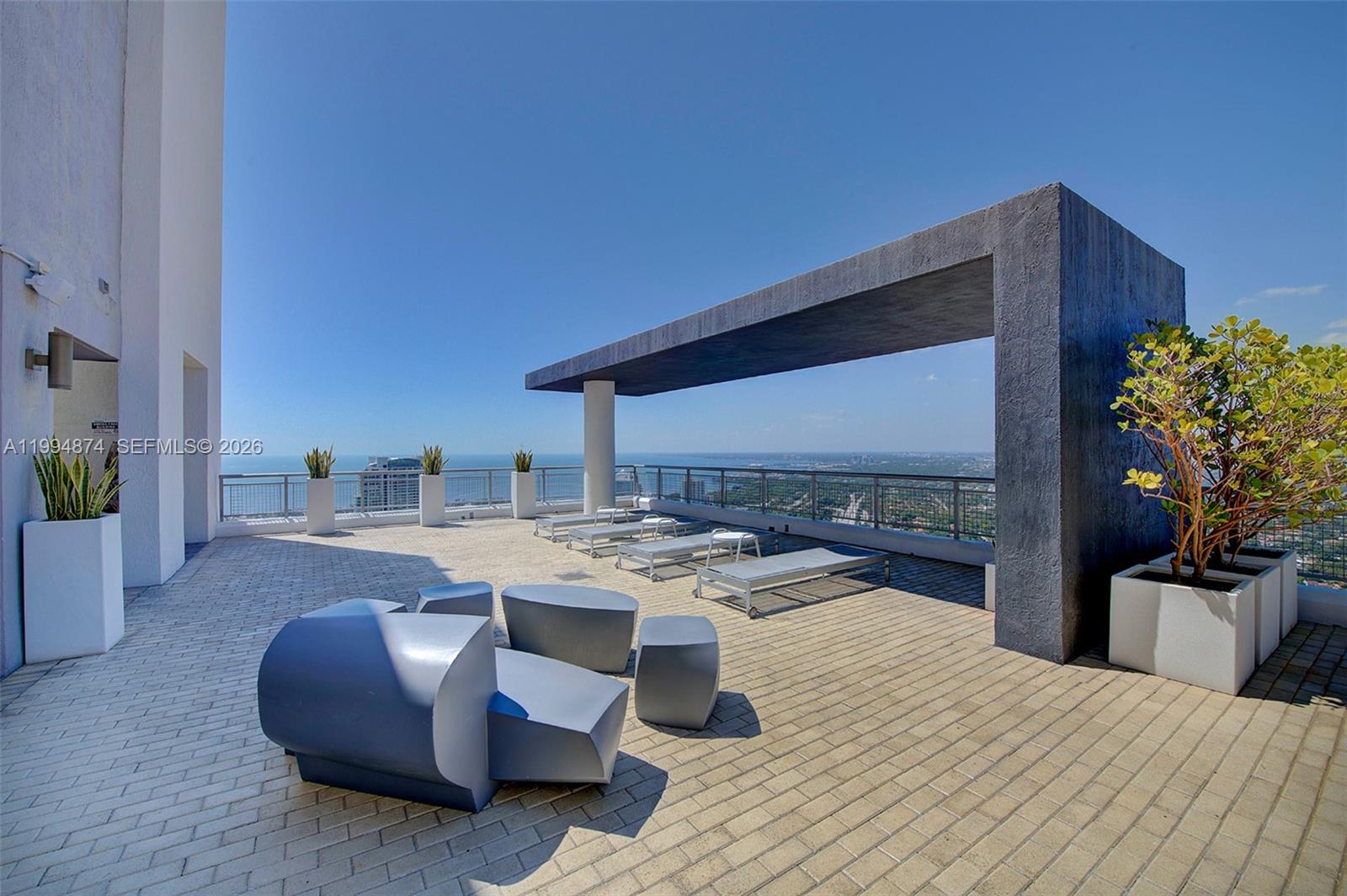 60 Southwest 13th Street, Unit 2820 Miami, FL 33130 - Photo 18 of 25 a living room with stainless steel appliances kitchen island granite countertop furniture a rug and a kitchen counter top