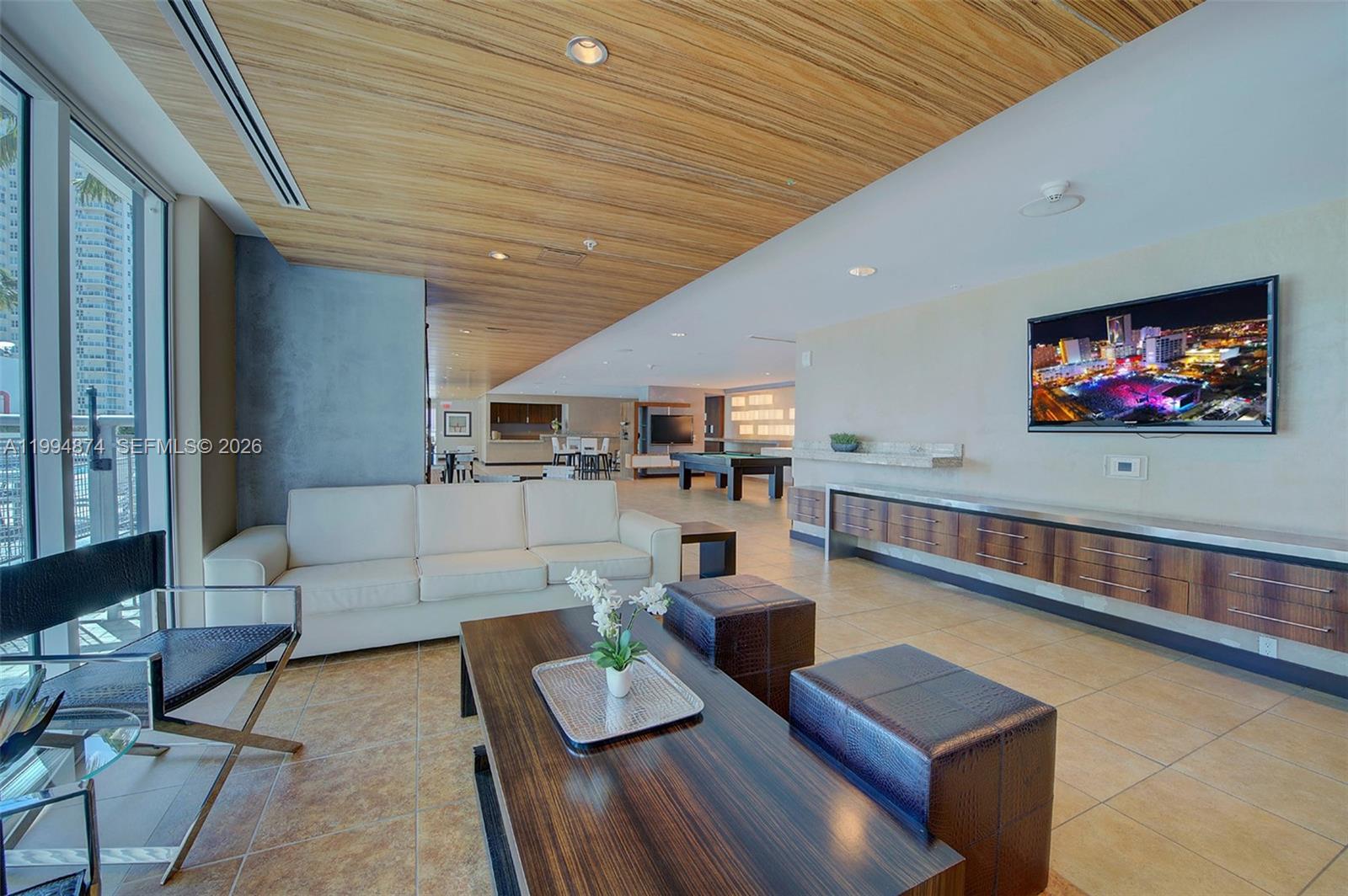 60 Southwest 13th Street, Unit 2820 Miami, FL 33130 - Photo 21 of 25 a living room with furniture and a flat screen tv