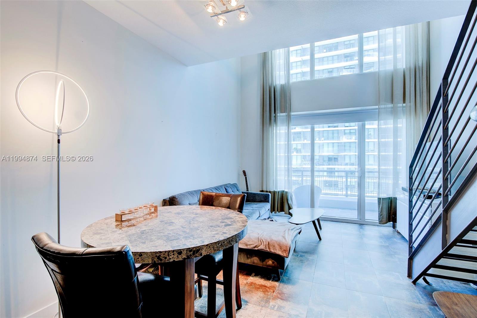 60 Southwest 13th Street, Unit 2820 Miami, FL 33130 - Photo 3 of 25 a view of a dining room with furniture and a window