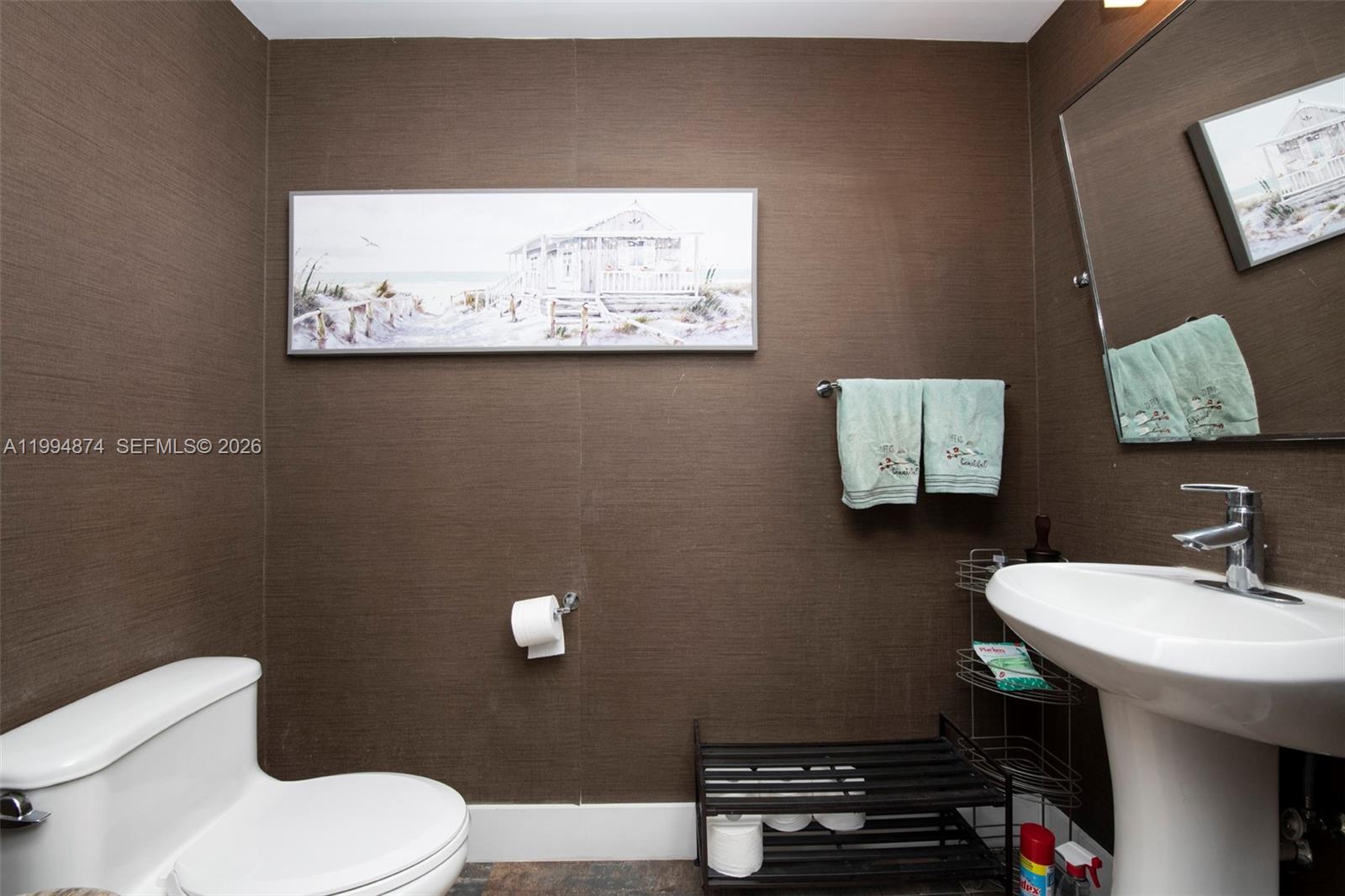 60 Southwest 13th Street, Unit 2820 Miami, FL 33130 - Photo 6 of 25 a bathroom with a toilet a sink and mirror