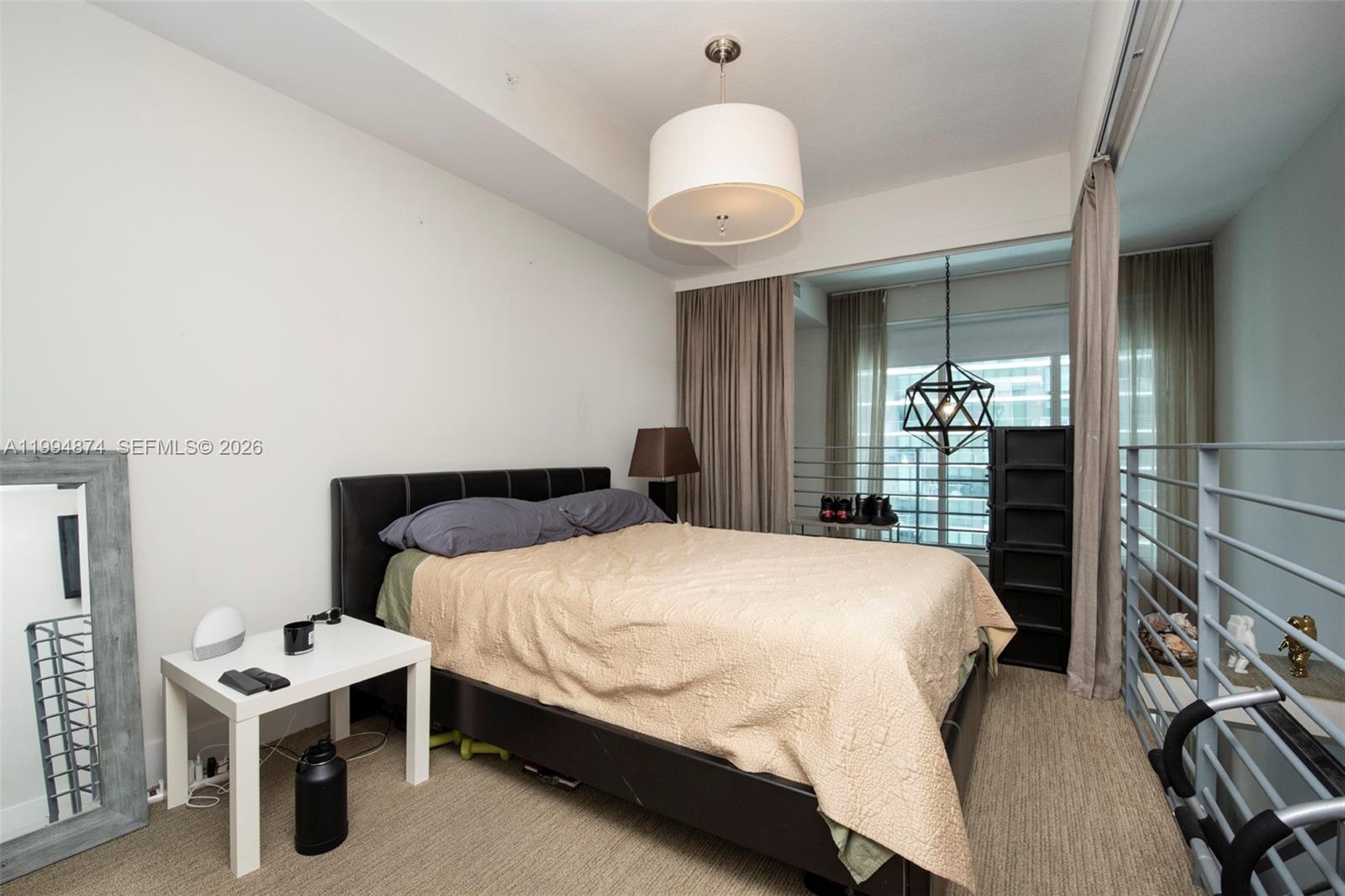 60 Southwest 13th Street, Unit 2820 Miami, FL 33130 - Photo 7 of 25 a bedroom with a bed and a chandelier