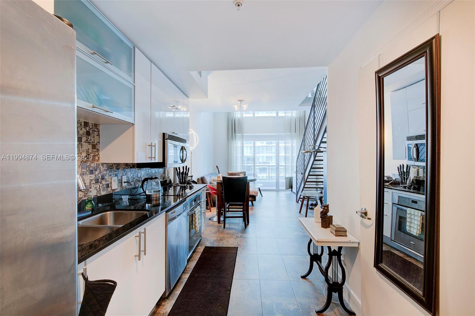 60 Southwest 13th Street, Unit 2820 Miami, FL 33130 - Photo 8 of 25 a kitchen with a sink and cabinets