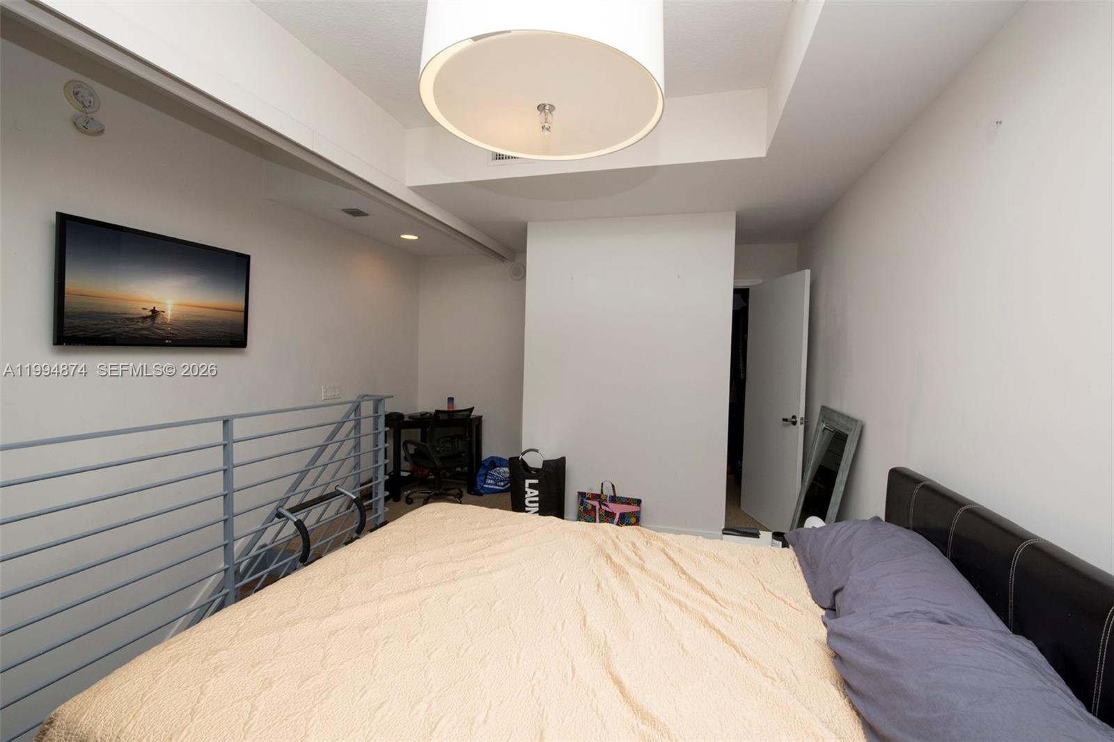 60 Southwest 13th Street, Unit 2820 Miami, FL 33130 - Photo 9 of 25 a bedroom with a bed and a flat screen tv