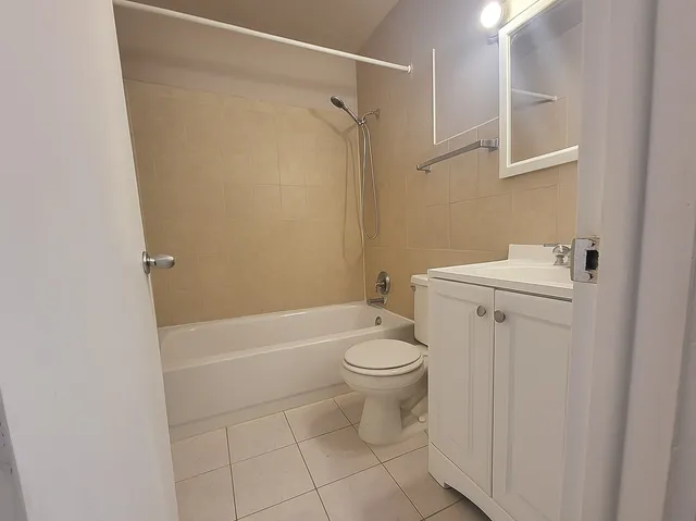 a white toilet sitting next to a bath tub