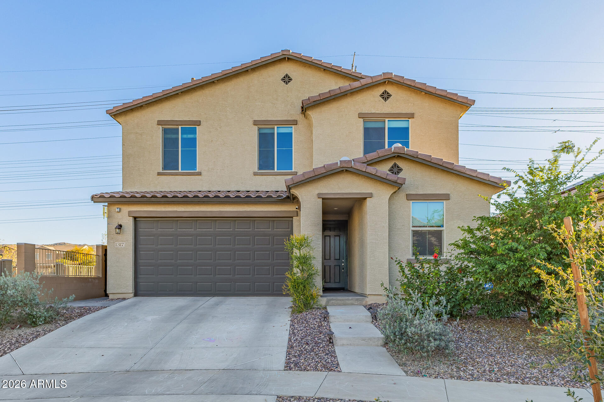1317 East Fremont Road Phoenix, AZ 85042 - Photo 1 of 41 a front view of a house with a yard and garage