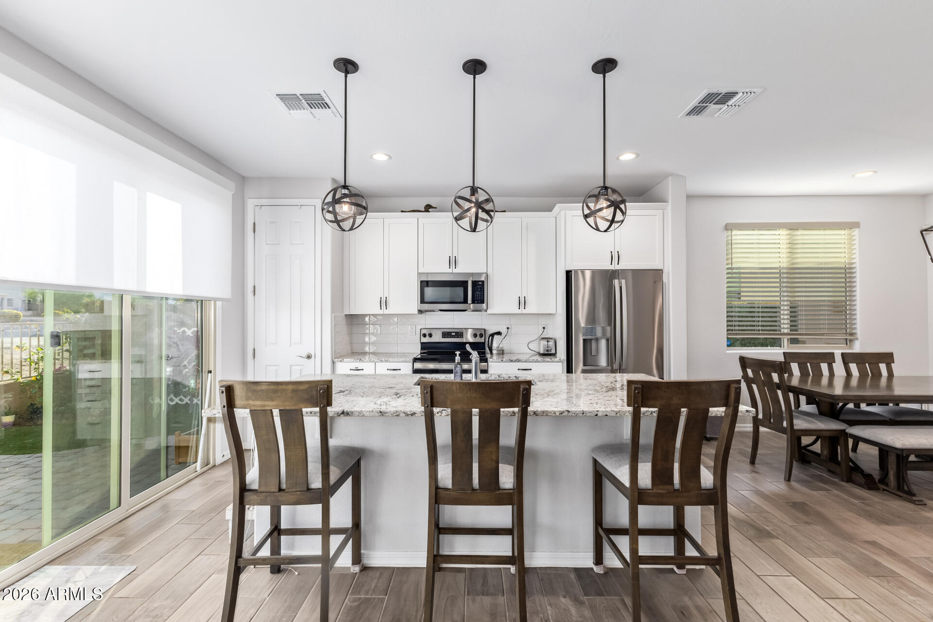 1317 East Fremont Road Phoenix, AZ 85042 - Photo 16 of 41 a kitchen with stainless steel appliances kitchen island granite countertop a dining table chairs and granite counter tops