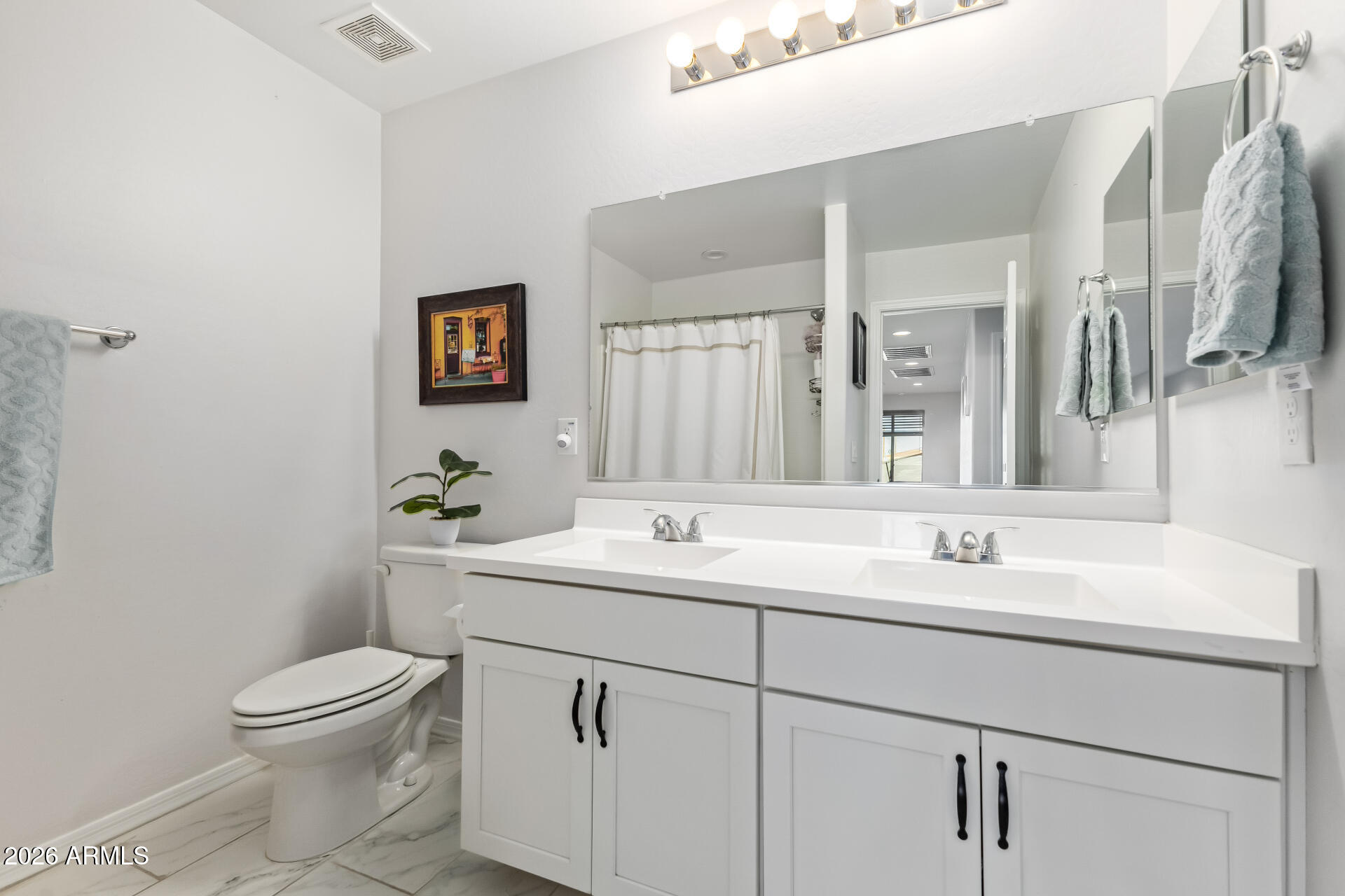 1317 East Fremont Road Phoenix, AZ 85042 - Photo 33 of 41 a bathroom with a toilet sink and mirror