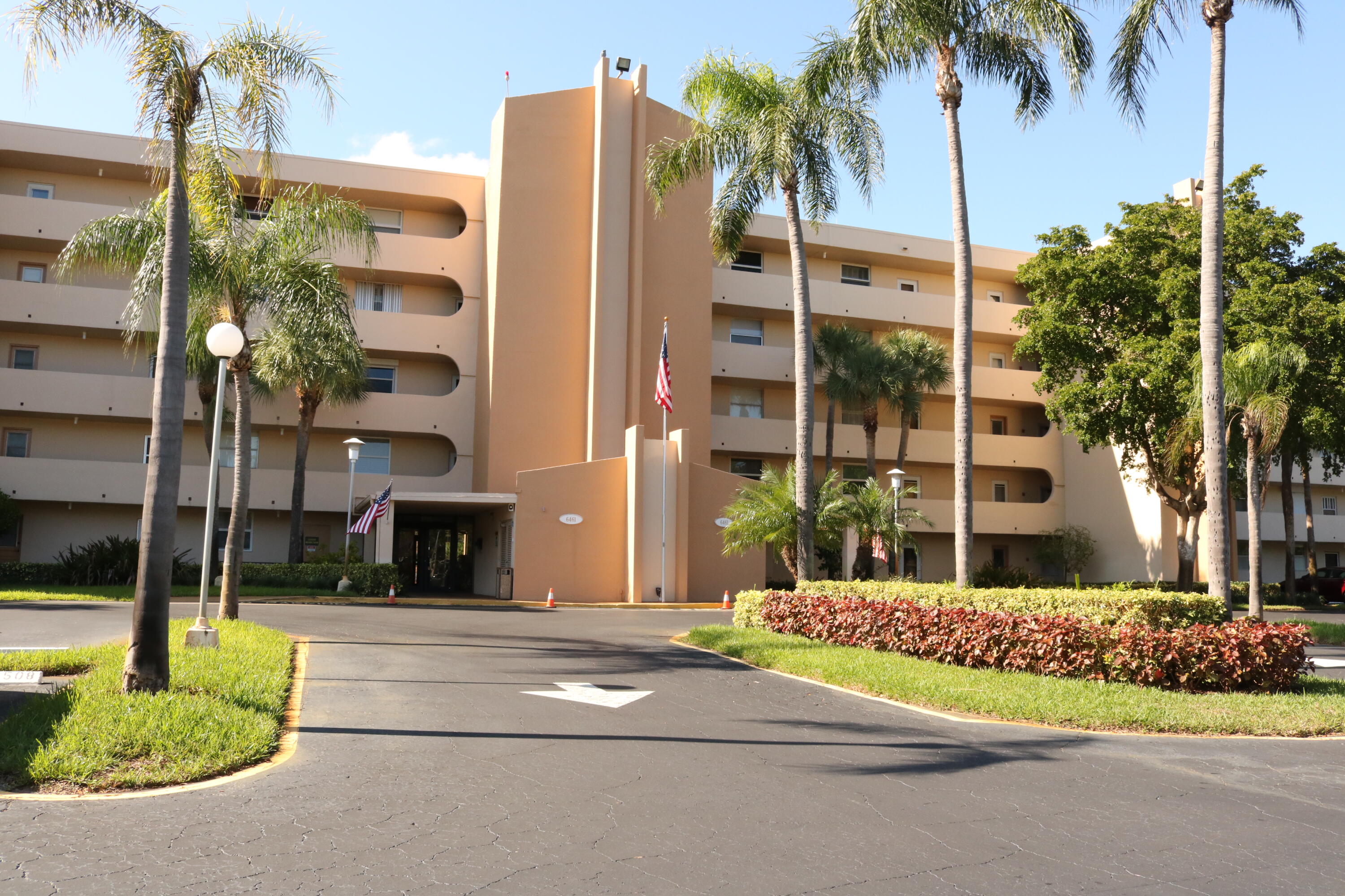 6461 Northwest 2nd Avenue, Unit 508 Boca Raton, FL 33487 - Photo 1 of 39 a front view of multi story residential apartment building with yard and sign board