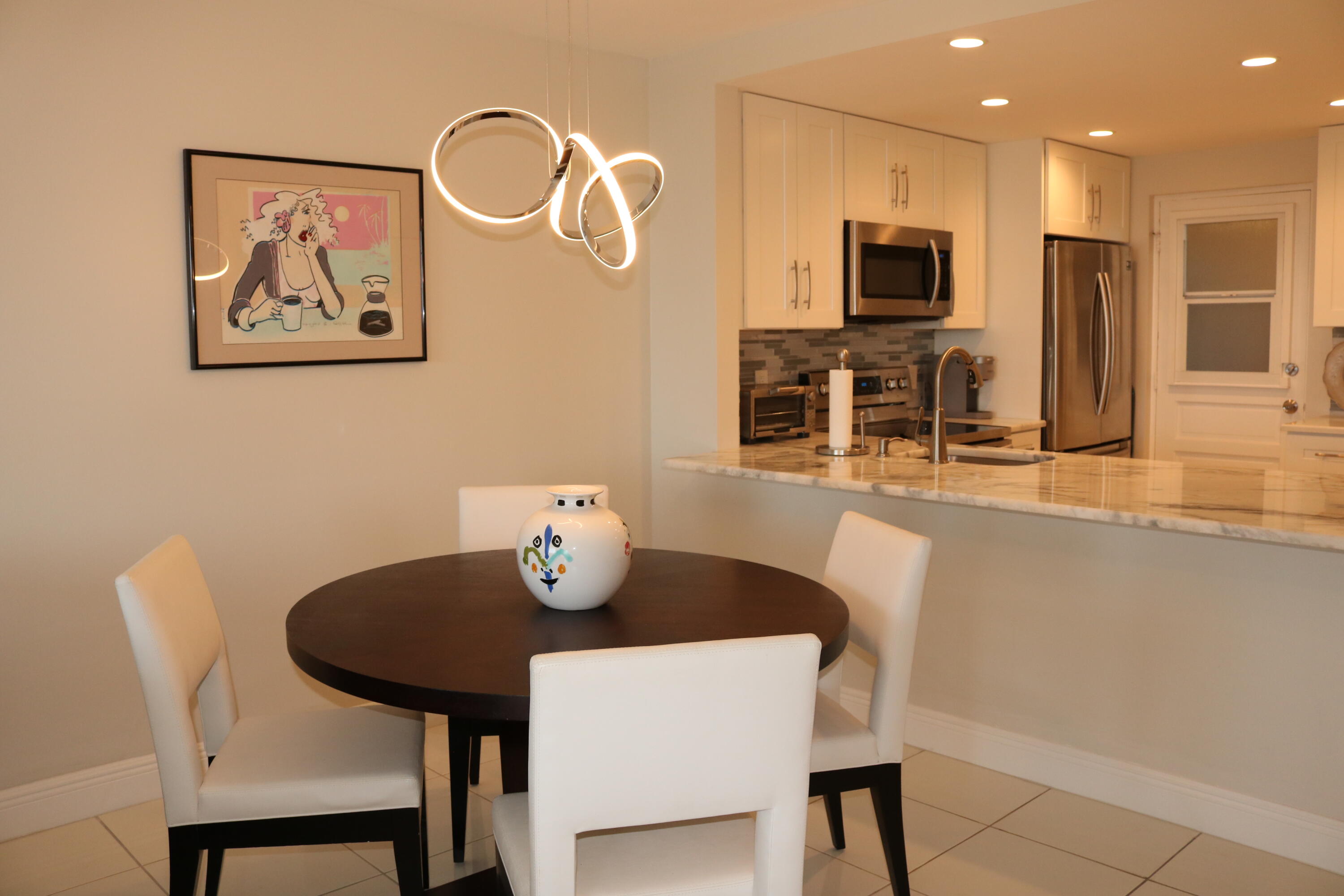 6461 Northwest 2nd Avenue, Unit 508 Boca Raton, FL 33487 - Photo 11 of 39 a view of a dining room with furniture