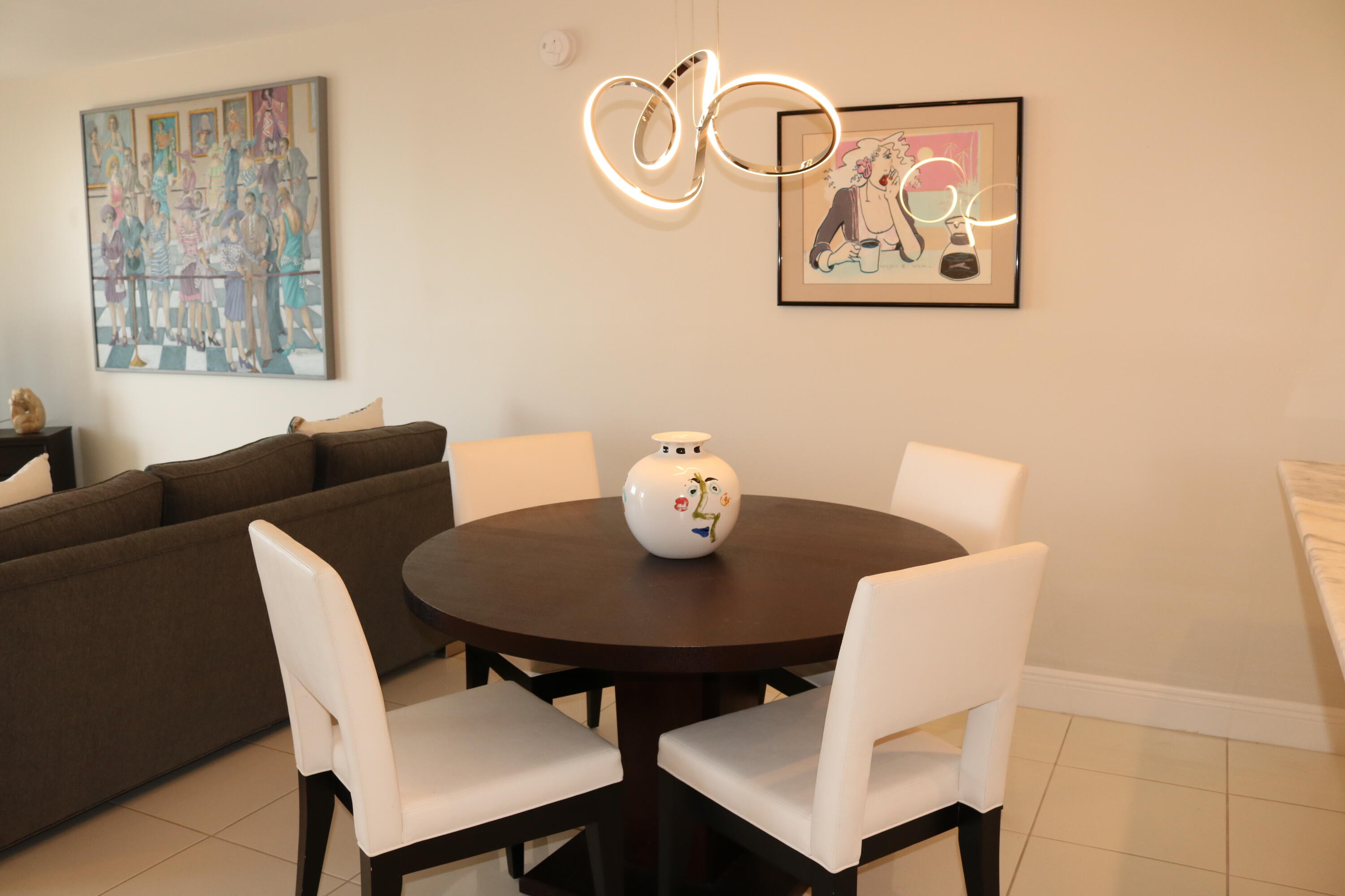 6461 Northwest 2nd Avenue, Unit 508 Boca Raton, FL 33487 - Photo 13 of 39 a view of a dining room with furniture and wooden floor