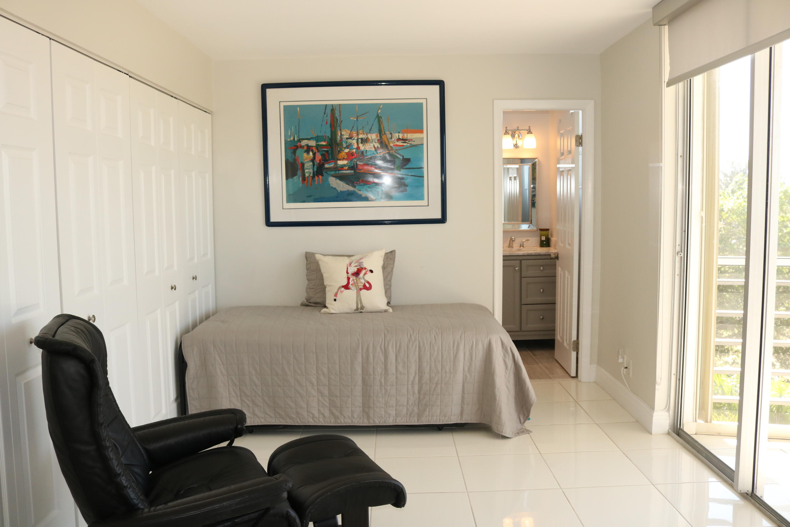 6461 Northwest 2nd Avenue, Unit 508 Boca Raton, FL 33487 - Photo 21 of 39 a bedroom with a bed and a painting on the wall