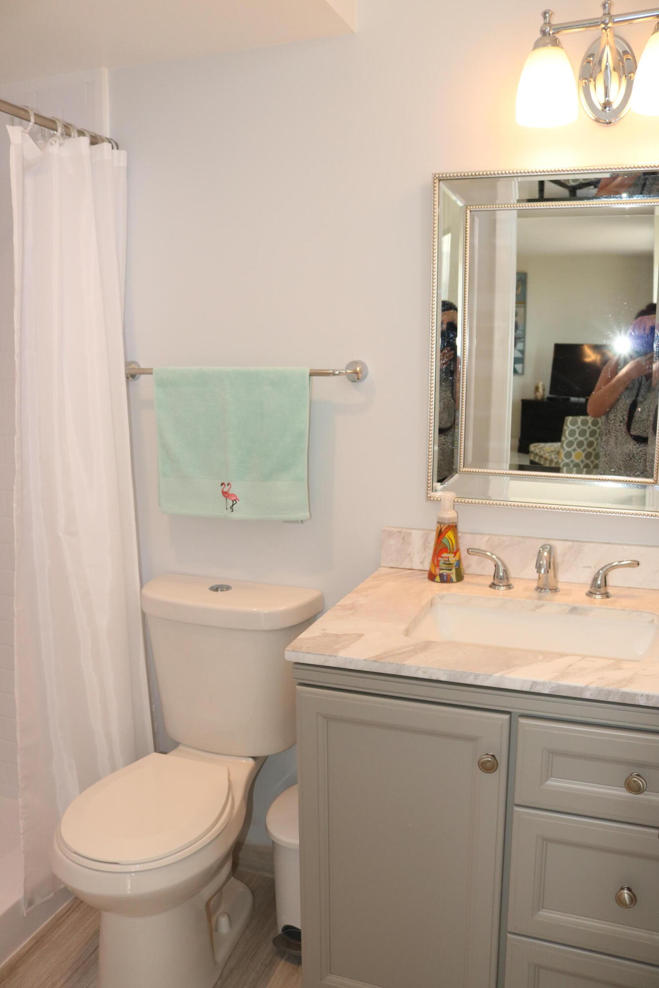 6461 Northwest 2nd Avenue, Unit 508 Boca Raton, FL 33487 - Photo 22 of 39 a bathroom with a toilet sink vanity and mirror