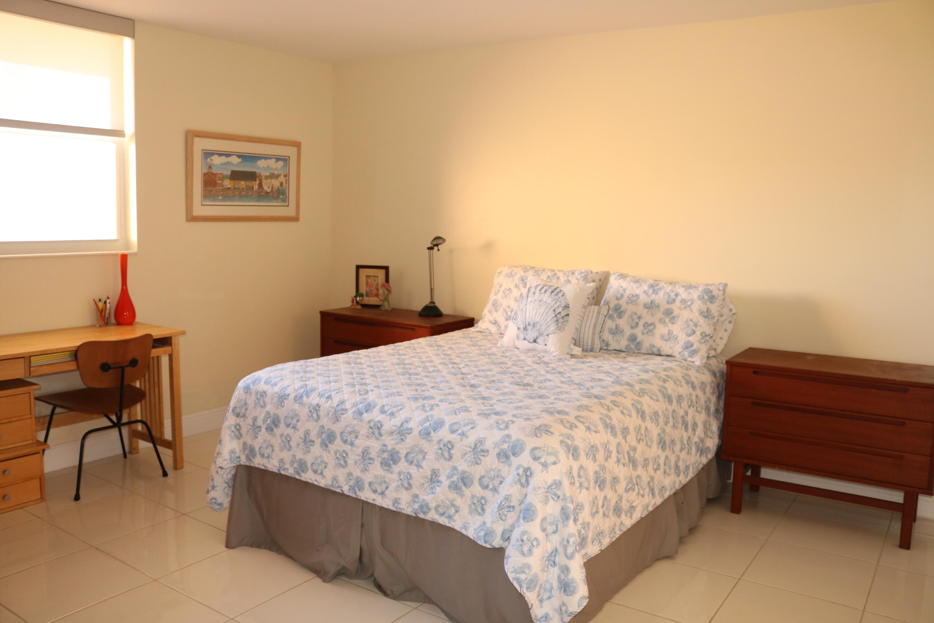 6461 Northwest 2nd Avenue, Unit 508 Boca Raton, FL 33487 - Photo 27 of 39 a bedroom with a bed and a desk