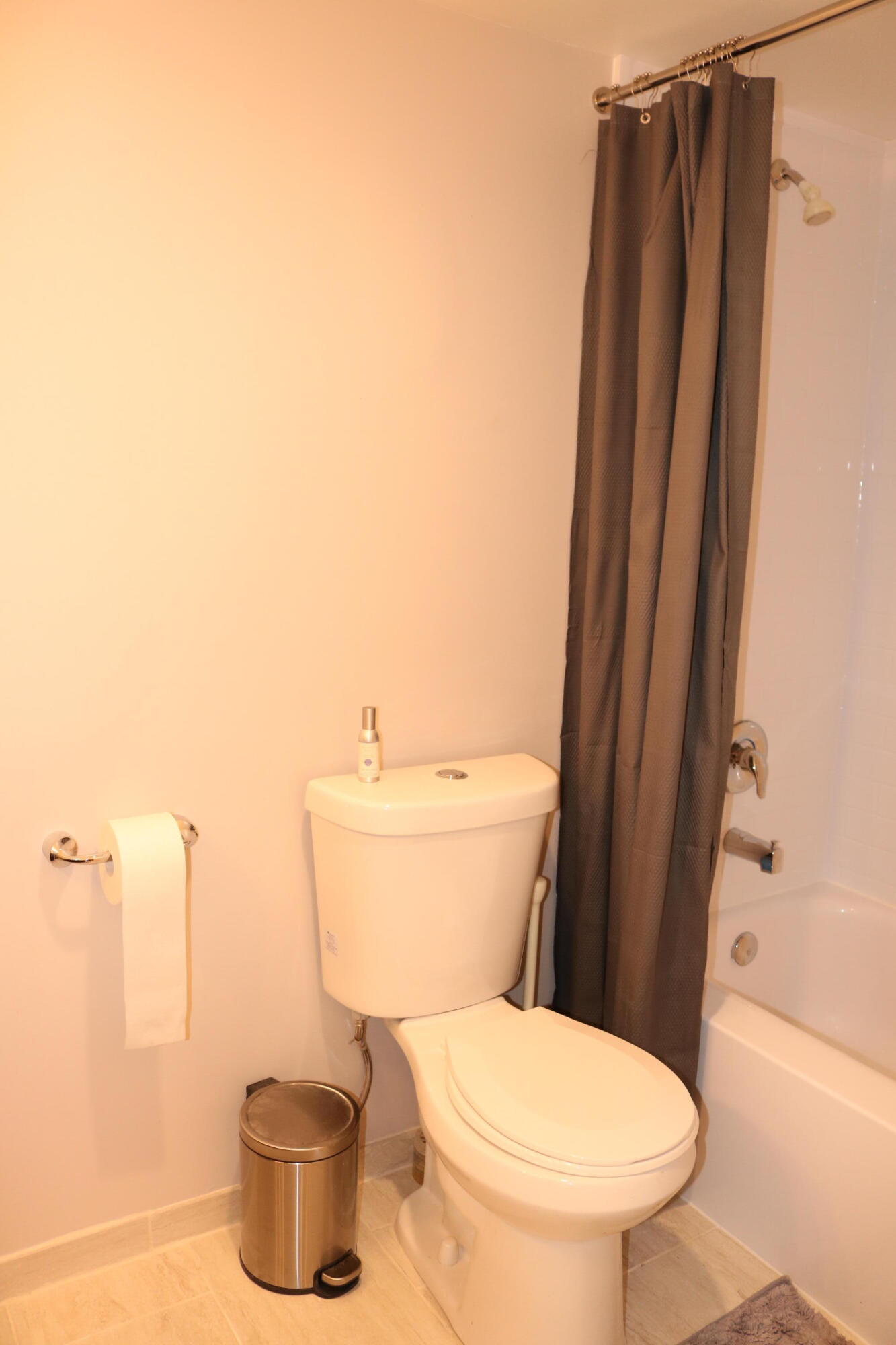 6461 Northwest 2nd Avenue, Unit 508 Boca Raton, FL 33487 - Photo 33 of 39 a white toilet sitting next to a shower curtain