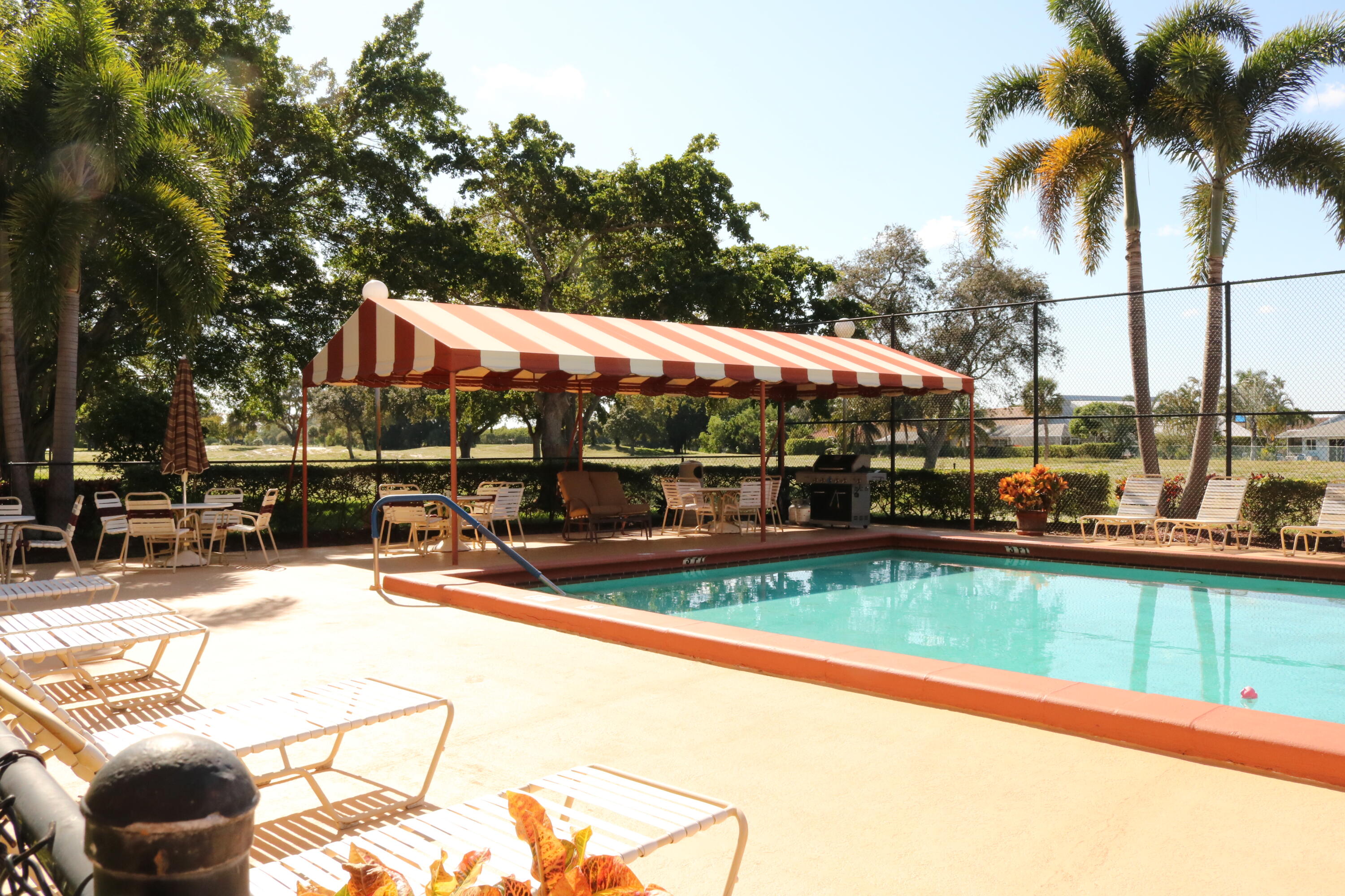 6461 Northwest 2nd Avenue, Unit 508 Boca Raton, FL 33487 - Photo 34 of 39 a view of a swimming pool with a patio and a garden