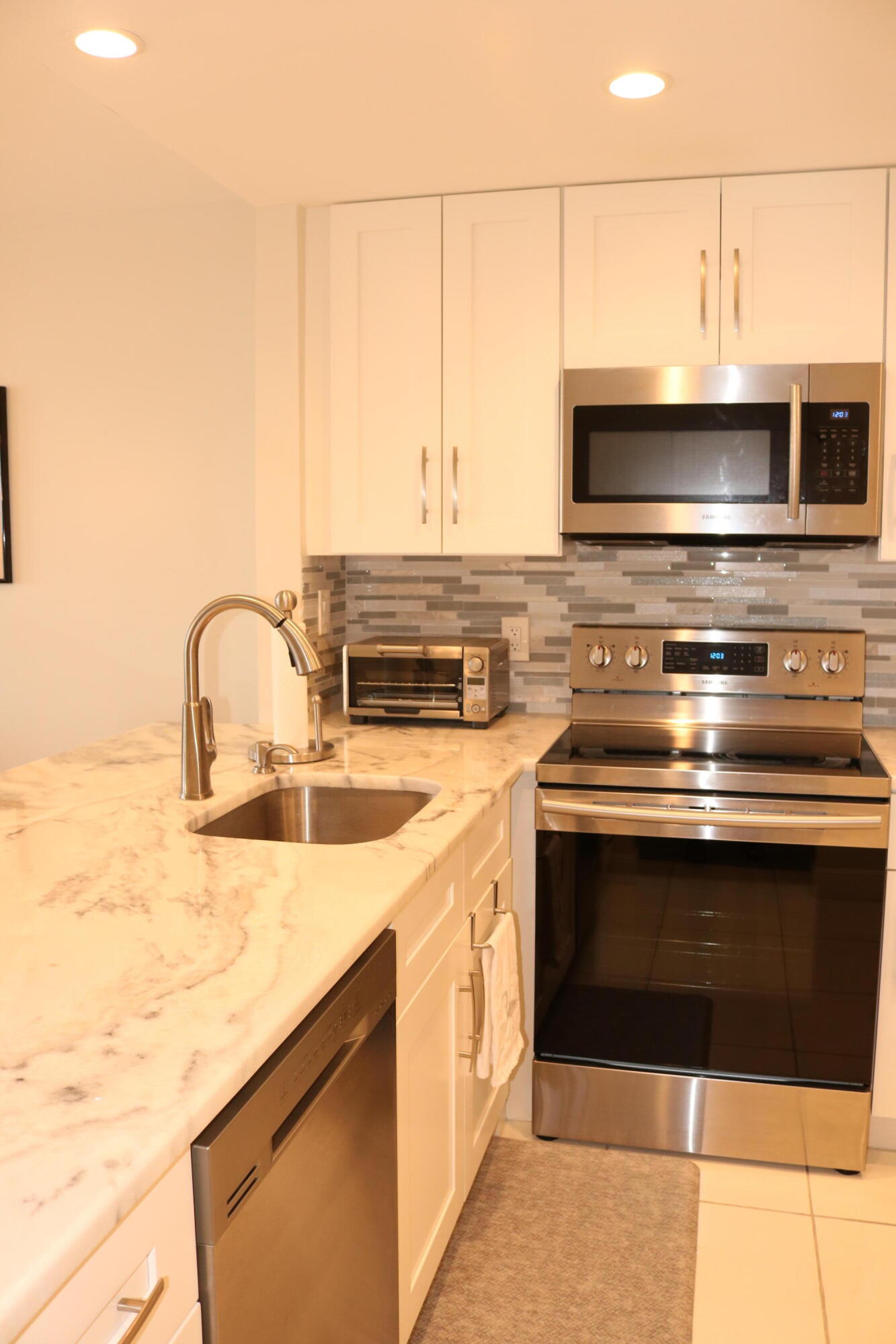6461 Northwest 2nd Avenue, Unit 508 Boca Raton, FL 33487 - Photo 7 of 39 a kitchen with a stove and a sink