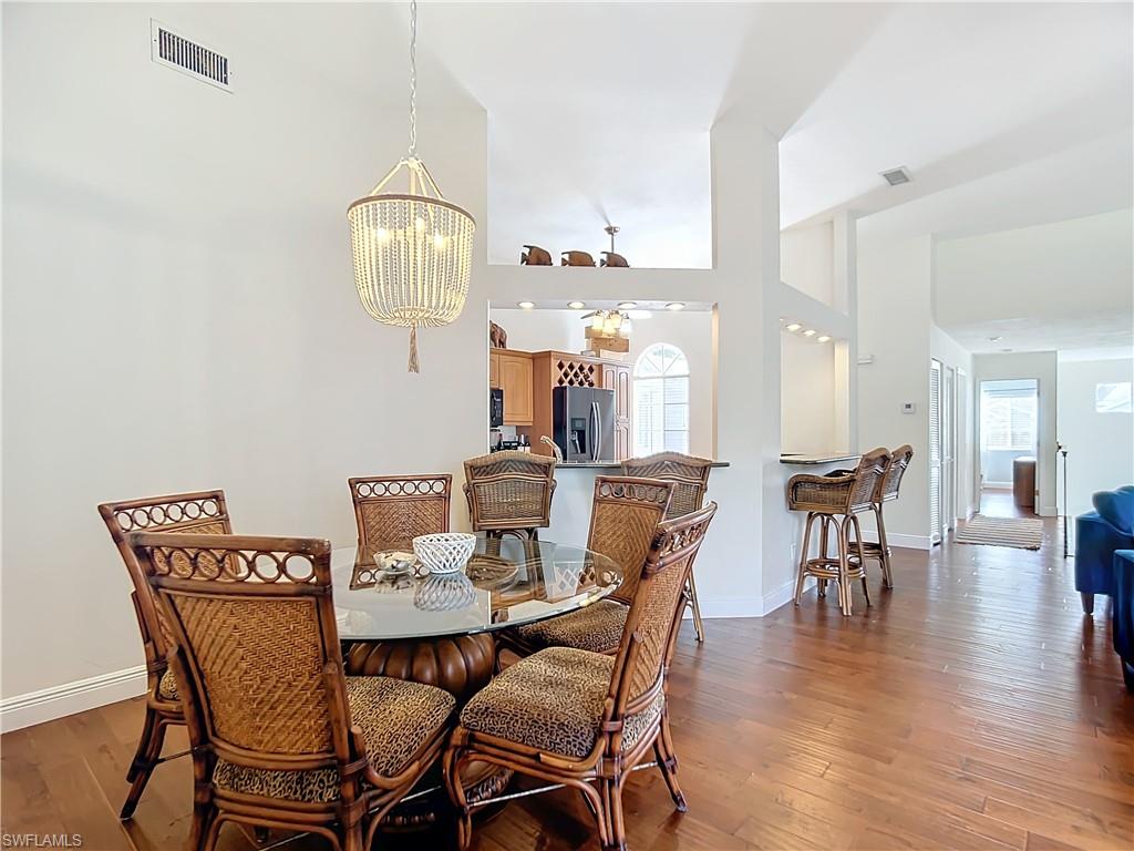 2860 Citrus Lake Drive, Unit R202 Naples, FL 34109 - Photo 21 of 50 a view of a dining room with furniture and wooden floor