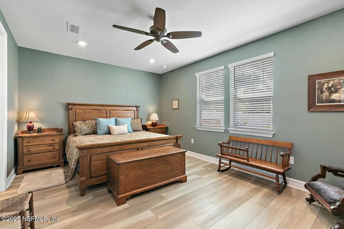 22 Myrtle Oak Court St. Augustine, FL 32092 - Photo 15 of 36 a bedroom with a bed and a chandelier