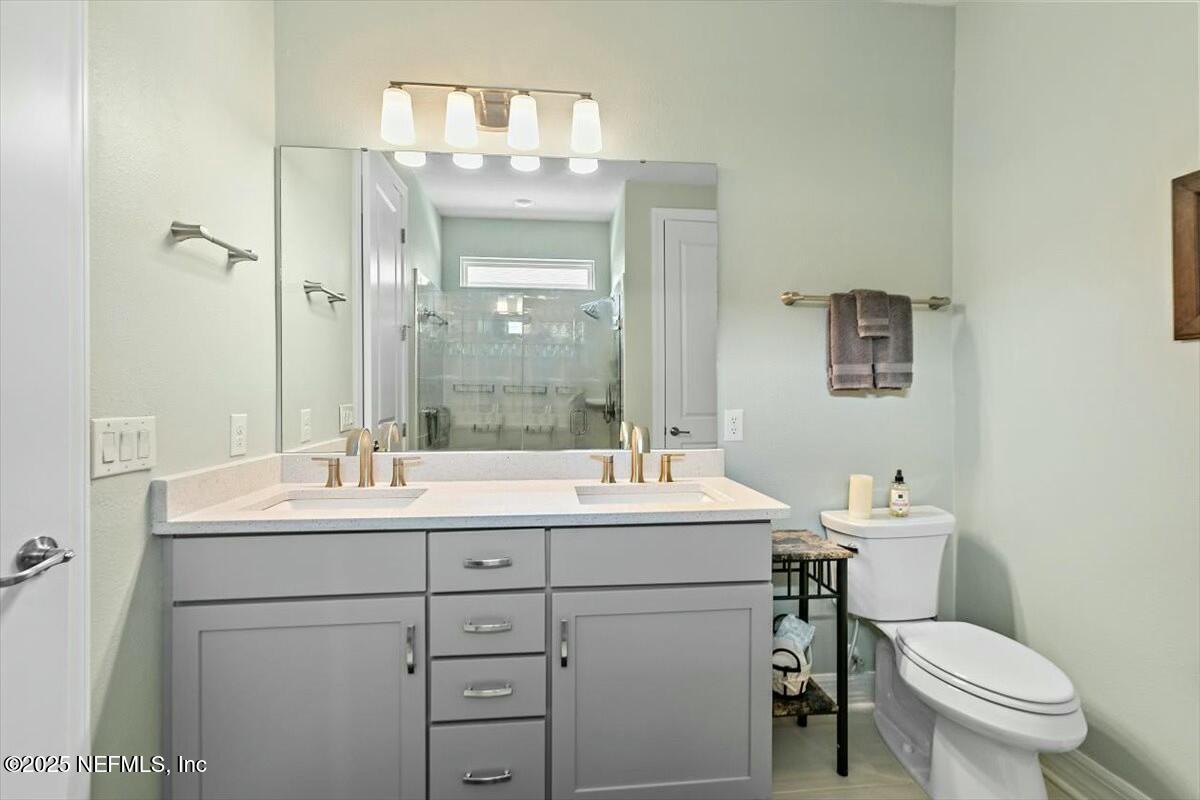 22 Myrtle Oak Court St. Augustine, FL 32092 - Photo 16 of 36 a bathroom with a toilet sink and mirror
