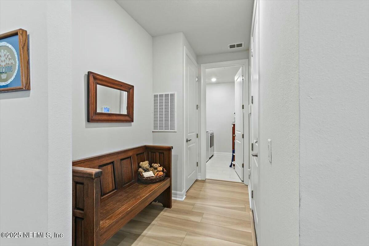 22 Myrtle Oak Court St. Augustine, FL 32092 - Photo 23 of 36 a view of a hallway with wooden floor and a bathroom
