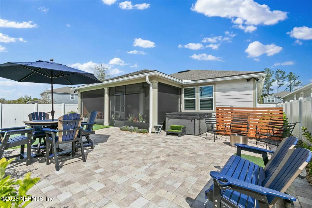 22 Myrtle Oak Court St. Augustine, FL 32092 - Photo 30 of 36 a view of a patio with a table and chairs under an umbrella with a fire pit
