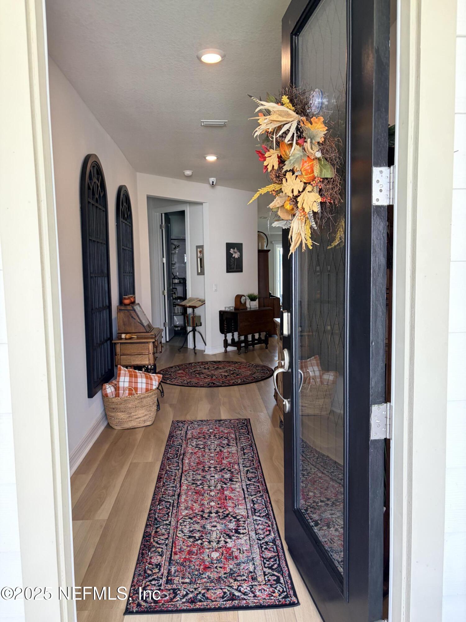 22 Myrtle Oak Court St. Augustine, FL 32092 - Photo 3 of 36 a hallway with beautiful frames and flower vase