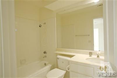 880 Congressional Road Simi Valley, CA 93065 - Photo 16 of 19 a bathroom with a granite countertop sink toilet and shower
