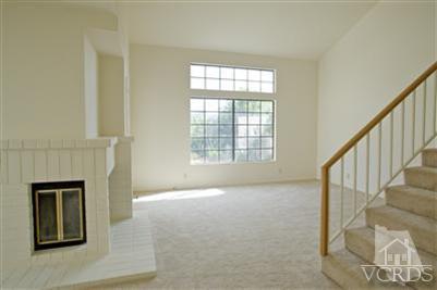 880 Congressional Road Simi Valley, CA 93065 - Photo 4 of 19 a view of an empty room with wooden floor and a window
