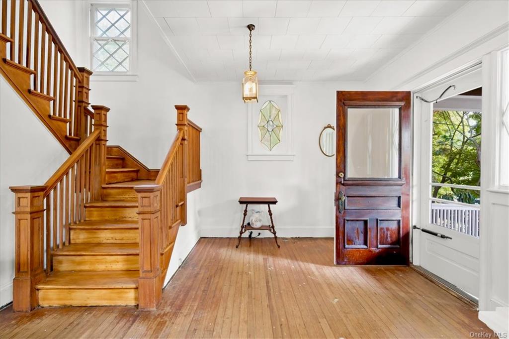 a view of entryway with wooden floor and stairs