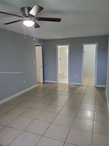 a view of a livingroom with a ceiling fan and window