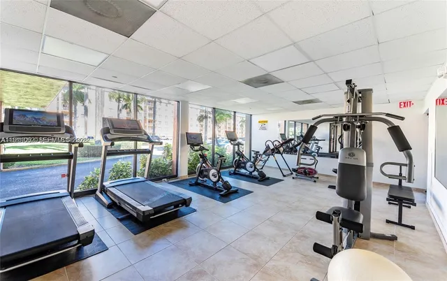 a living room with gym equipment and a table