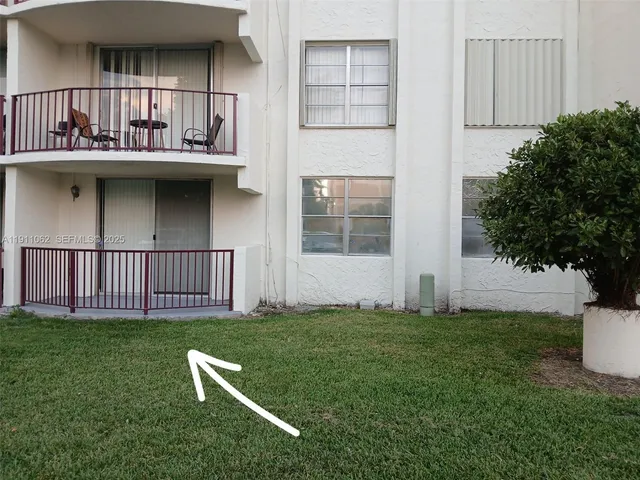 a view of a house with a yard and sitting area