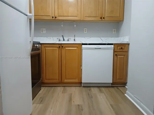 a view of kitchen with granite countertop cabinets and dryer