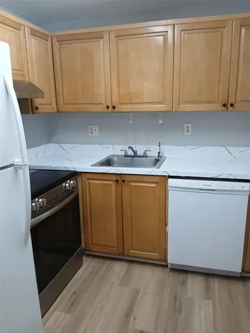 a kitchen with a sink and a stove top oven