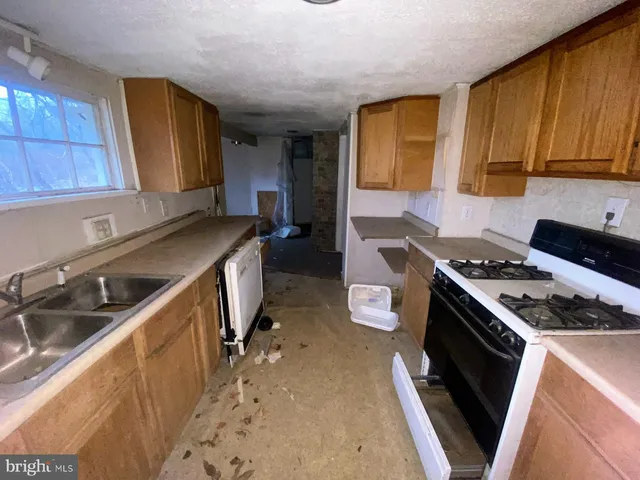 a kitchen with a stove a sink and a refrigerator