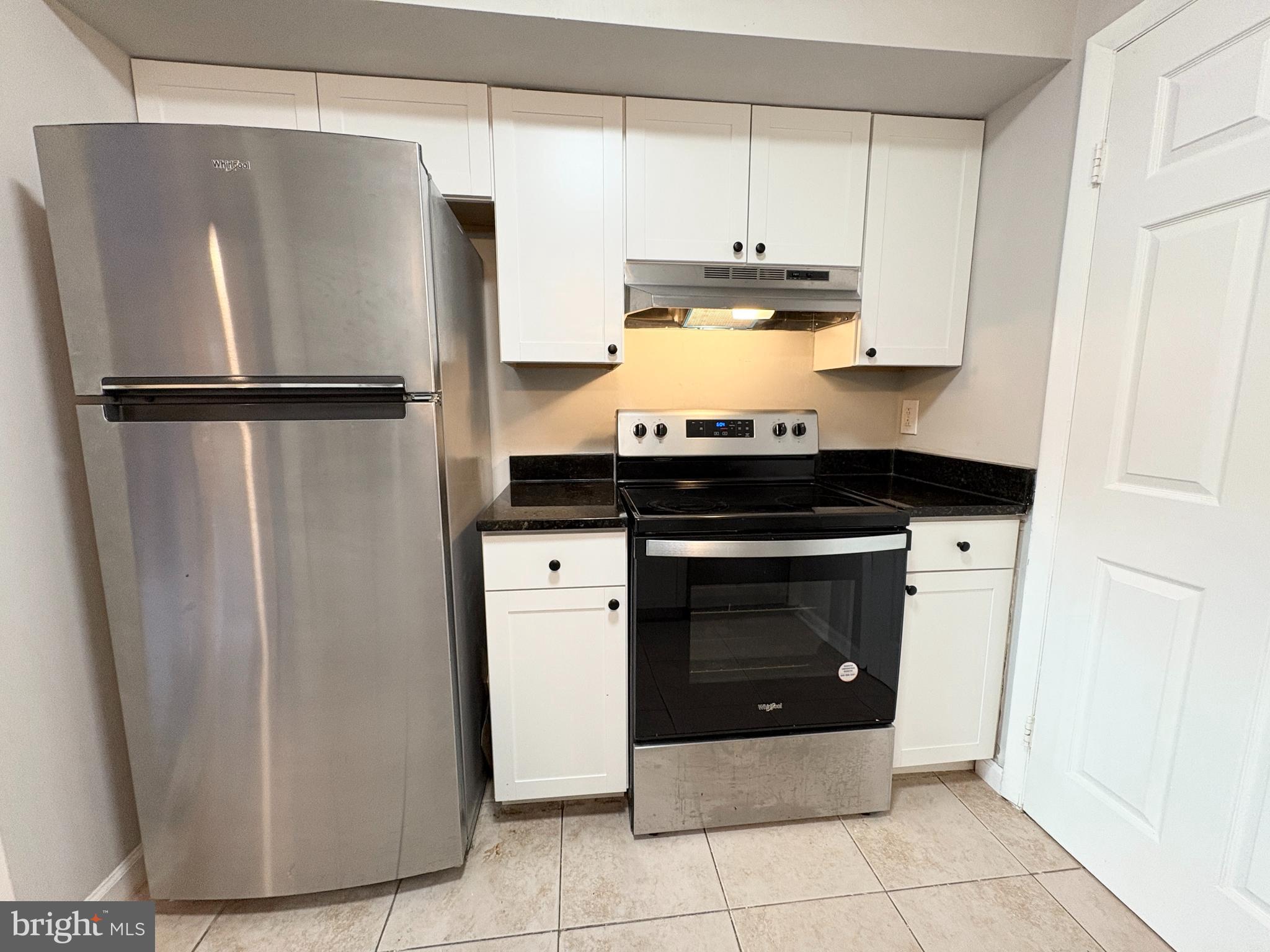 3813 Segundo Place, Unit D Alexandria, VA 22309 - Photo 11 of 28 a kitchen with stainless steel appliances granite countertop a refrigerator and a stove
