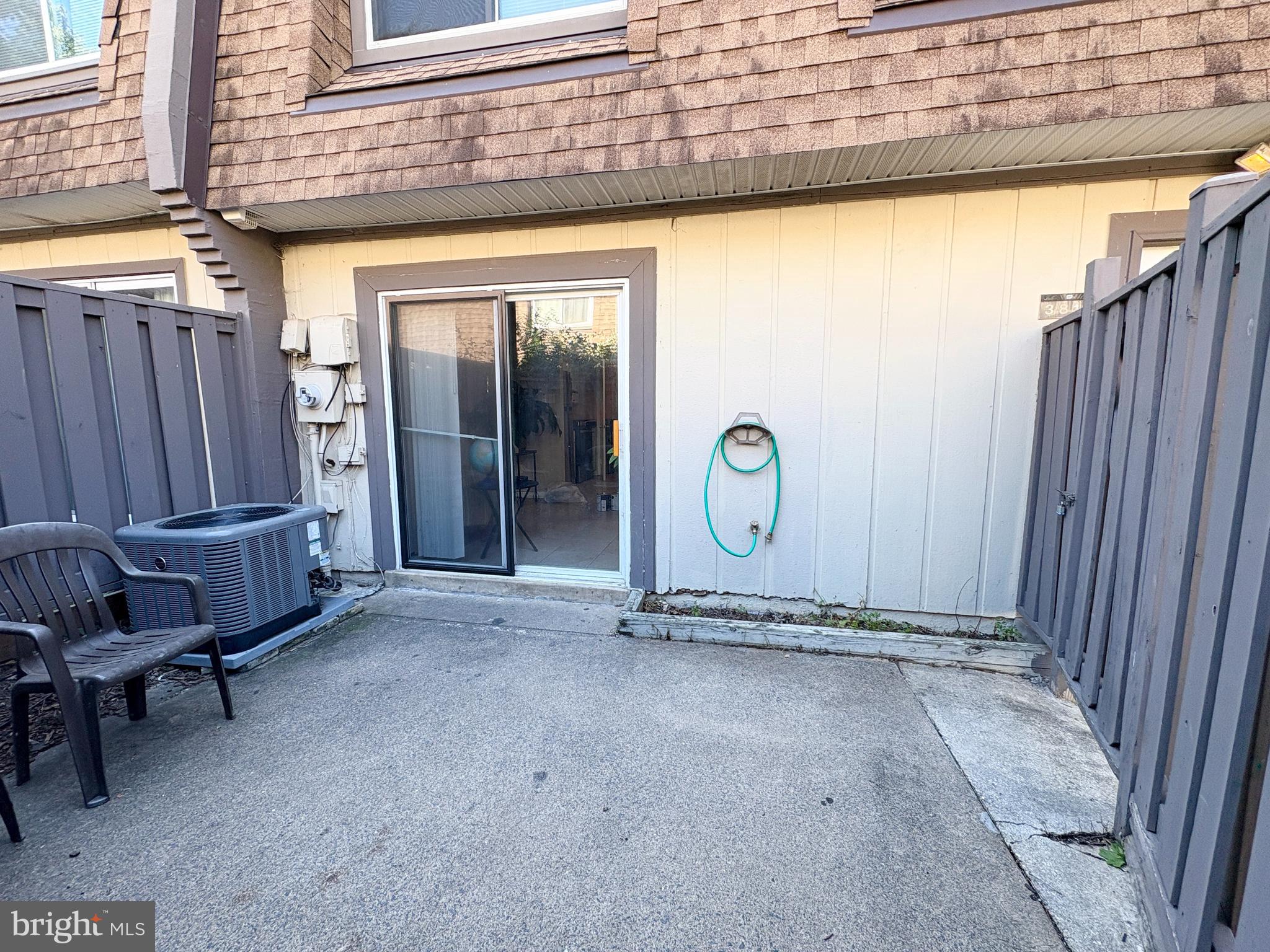 3813 Segundo Place, Unit D Alexandria, VA 22309 - Photo 24 of 28 a view of a door with a chair and wooden fence