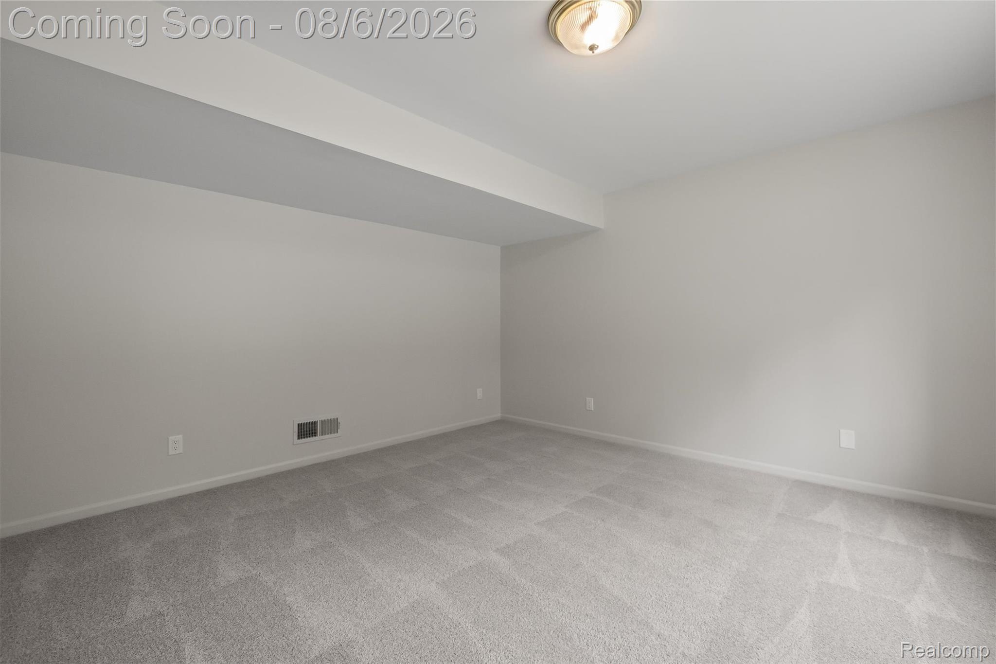 4427 Hannan Road Wayne, MI 48184 - Photo 23 of 33 Spacious room featuring light gray carpeting, neutral wall finishes, and a flush-mount ceiling light fixture