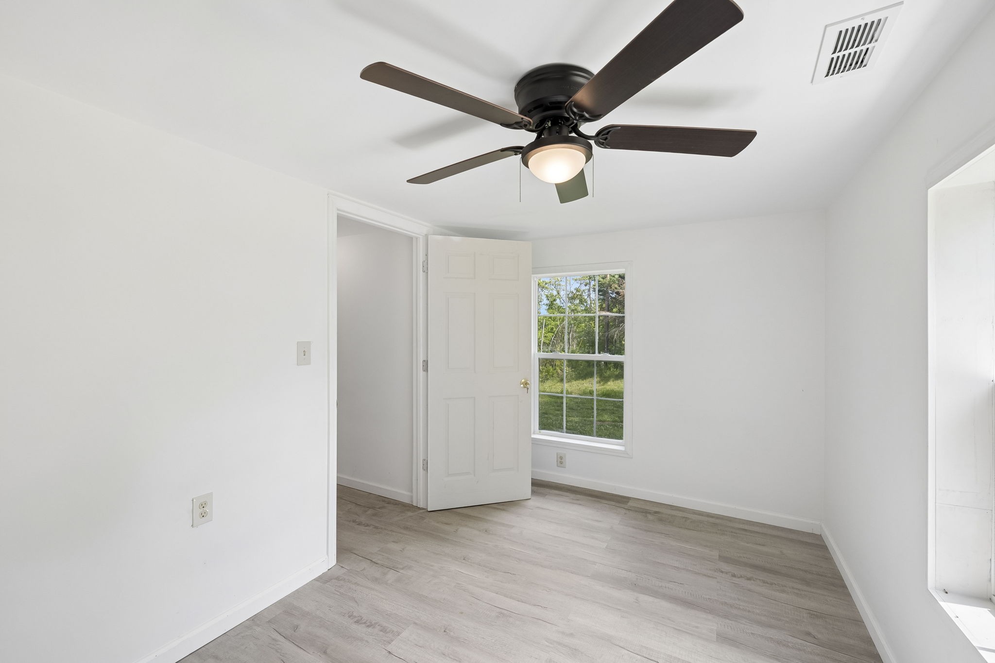 1200 Little Street Winchester, TN 37398 - Photo 16 of 54 an empty room with wooden floor ceiling fan and windows