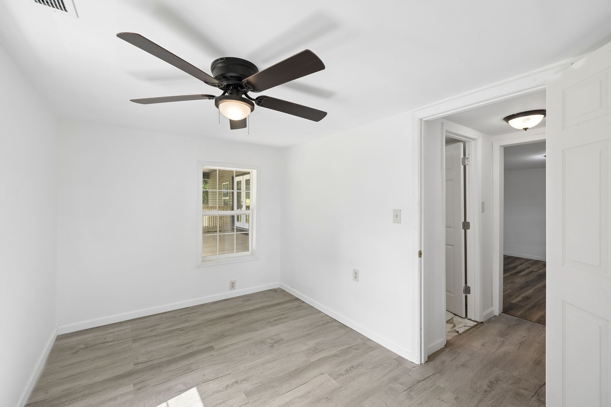 1200 Little Street Winchester, TN 37398 - Photo 17 of 54 an empty room with wooden floor ceiling fan and windows