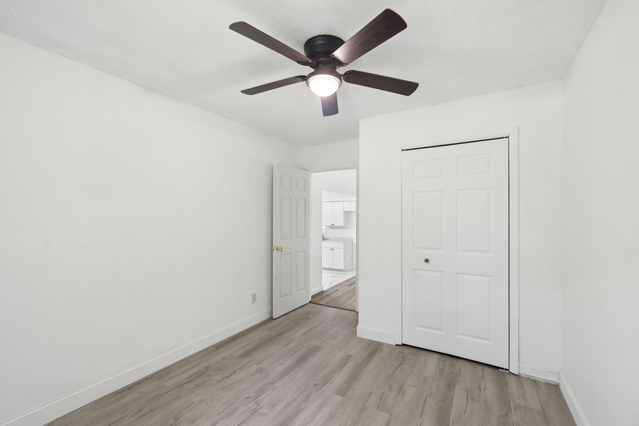 1200 Little Street Winchester, TN 37398 - Photo 32 of 54 an empty room with wooden floor ceiling fan and windows