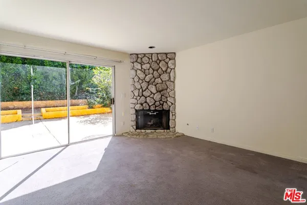 an empty room with a fireplace and painted walls
