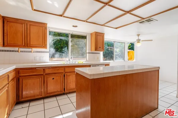 a kitchen with stainless steel appliances granite countertop a sink and a window