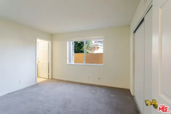 an empty room that has a window in it