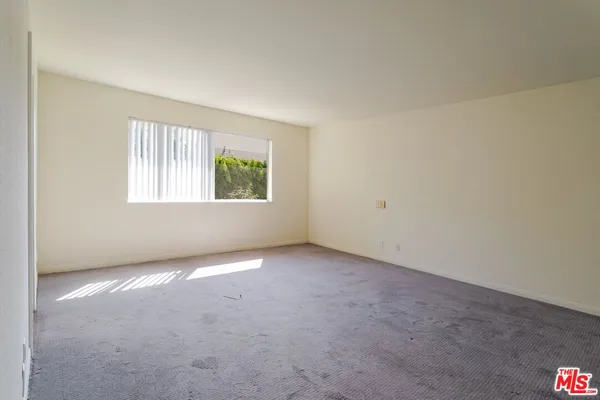 a view of an empty room and a window